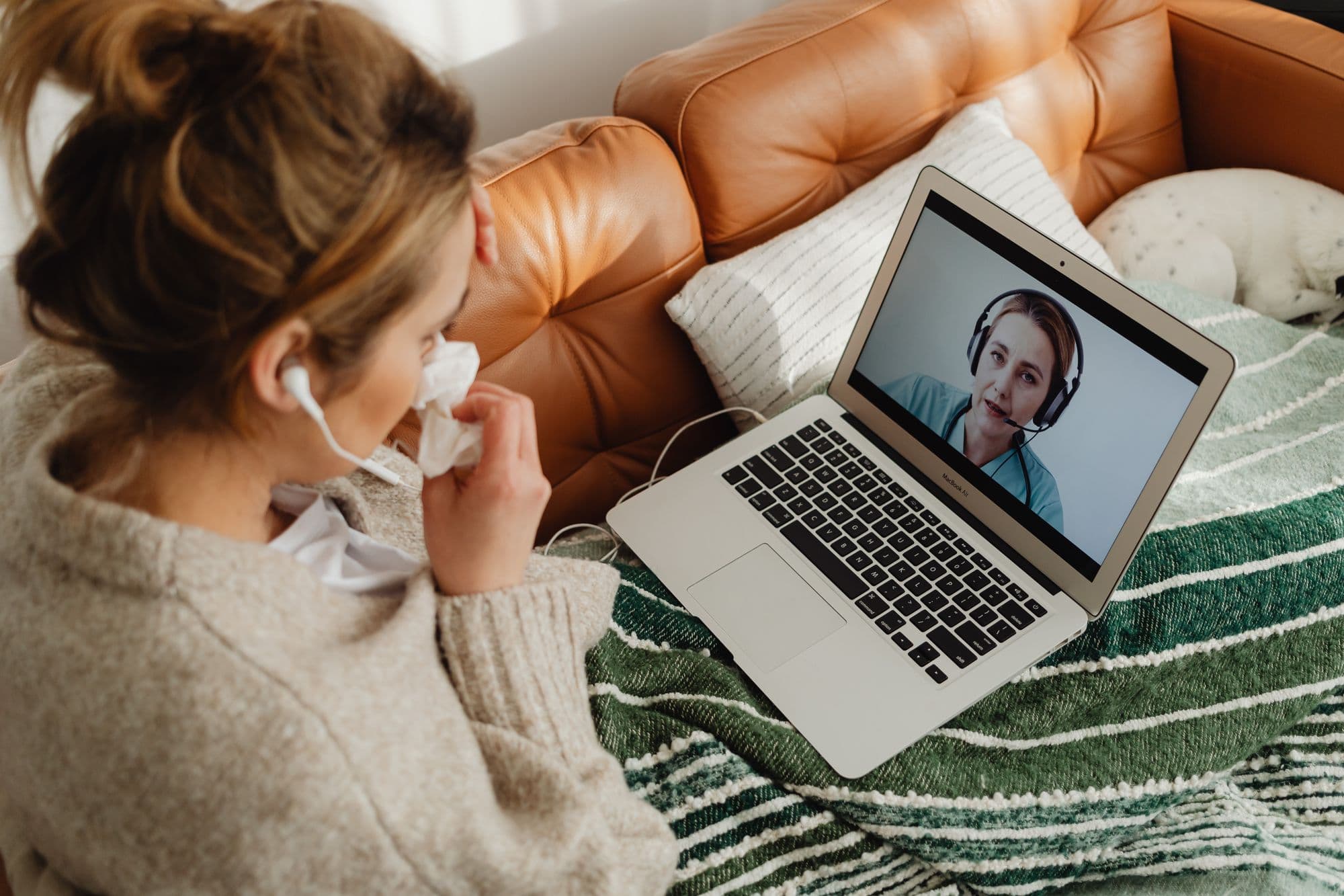 A patient at home speaking with their healthcare provider, visible on screen, during a virtual video visit